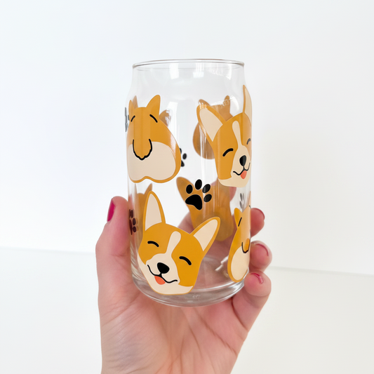 A glass cup with a bamboo lid and design featuring cartoon corgis.