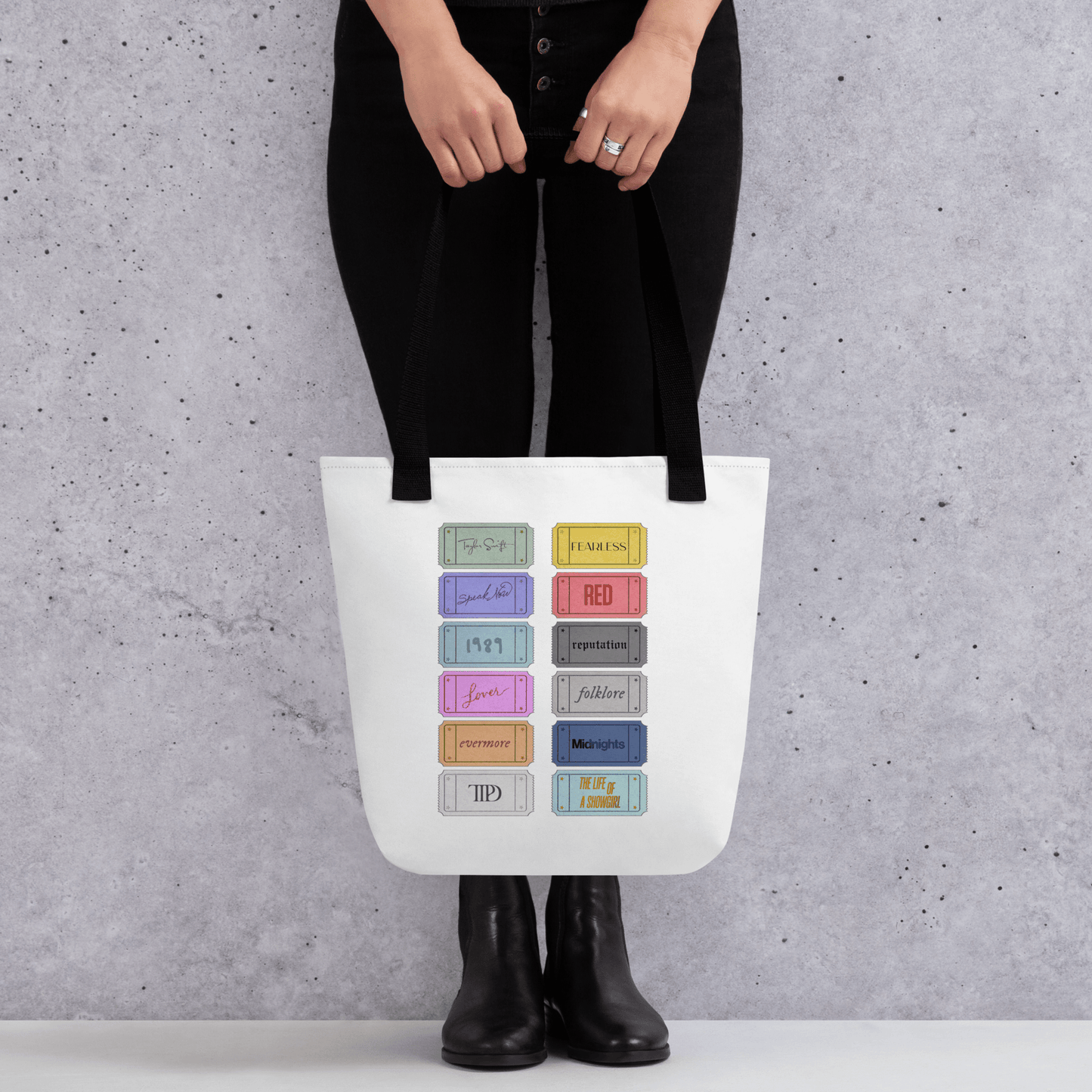 white Taylor 12 album shopping bag with all albums listed with black handles
