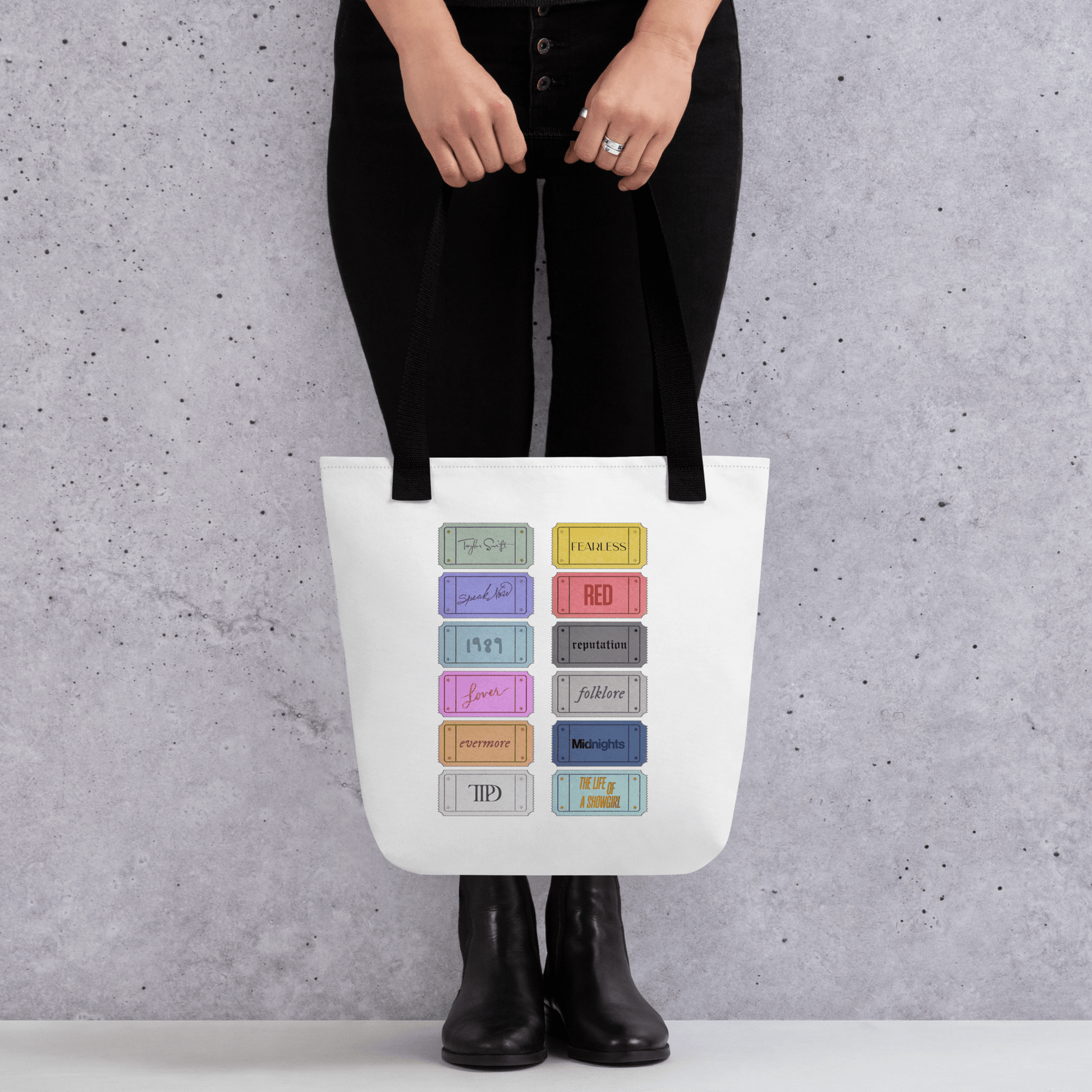 white Taylor 12 album shopping bag with all albums listed with black handles