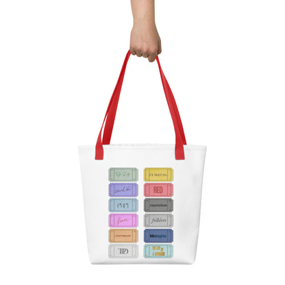 white Taylor 12 album shopping bag with all albums listed with red handles 
