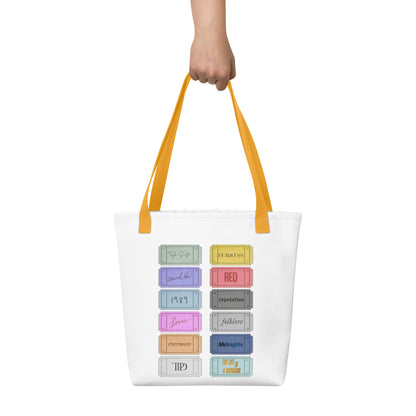 white Taylor 12 album shopping bag with all albums listed with yellow handles 