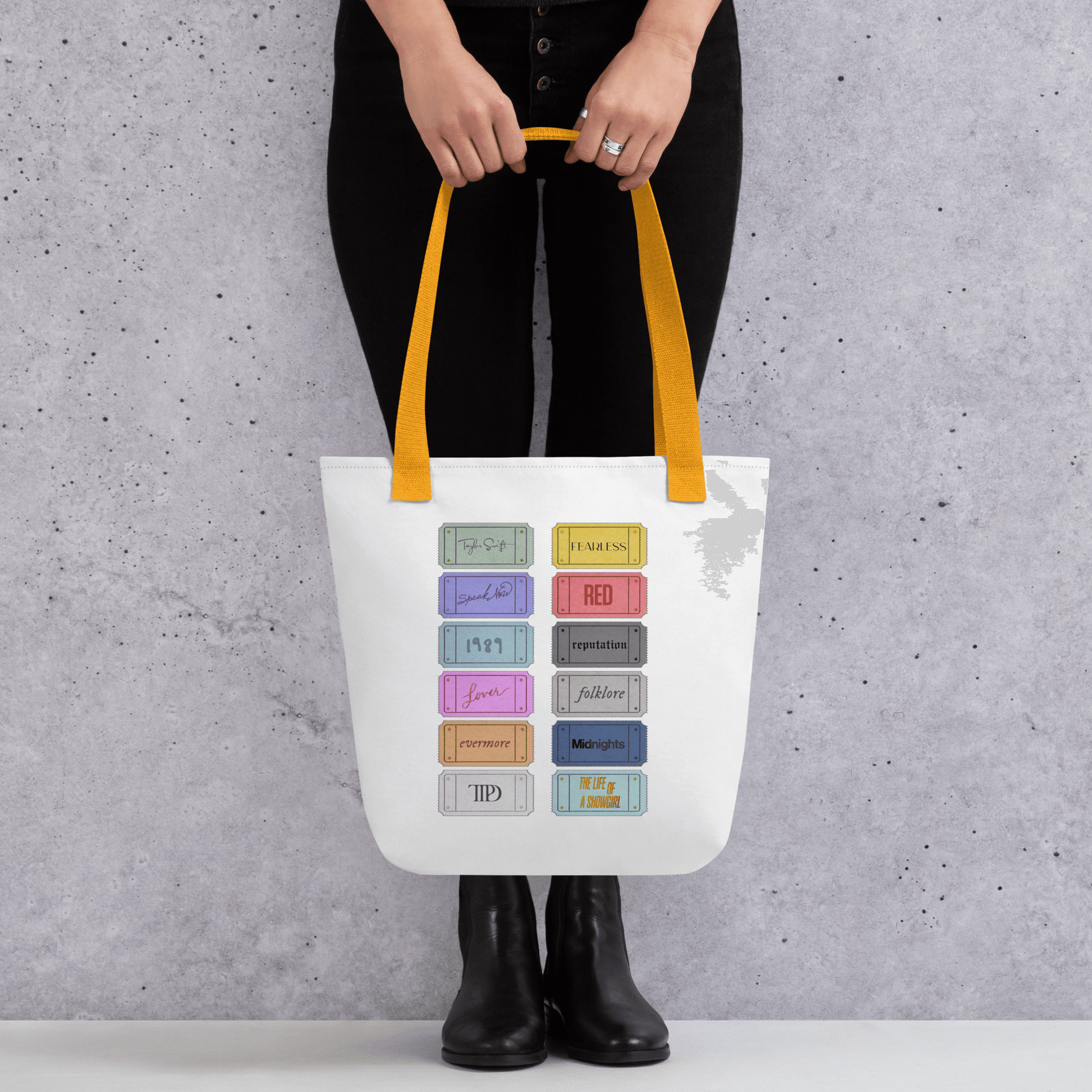 white Taylor 12 album shopping bag with all albums listed with yellow handles